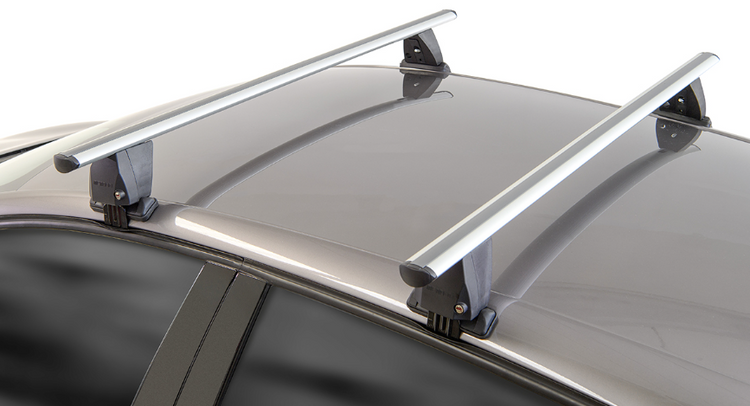 two grey roof bars clamped to a dark vehicle roof on a white background