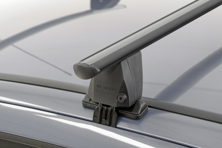 a black roof bar clamped to a dark vehicle roof