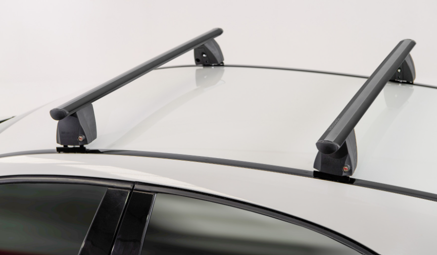 two black roof bars mounted on a white vehicle using a black bracket