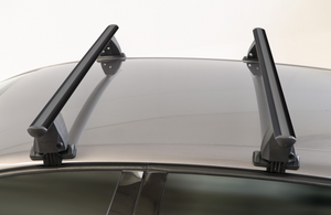 two black roof racks mounted on a brown vehicle