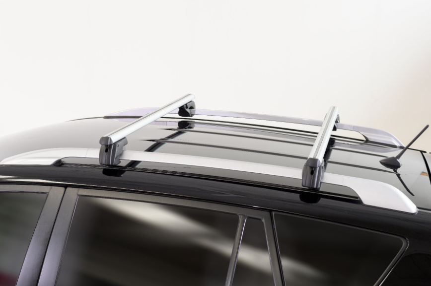 two grey menabo roof bars mounted on a vehicle