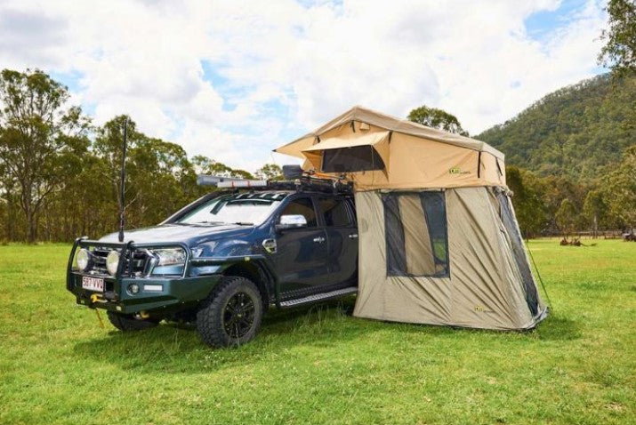 pick-up parked in a meadow with a roof tent and annex