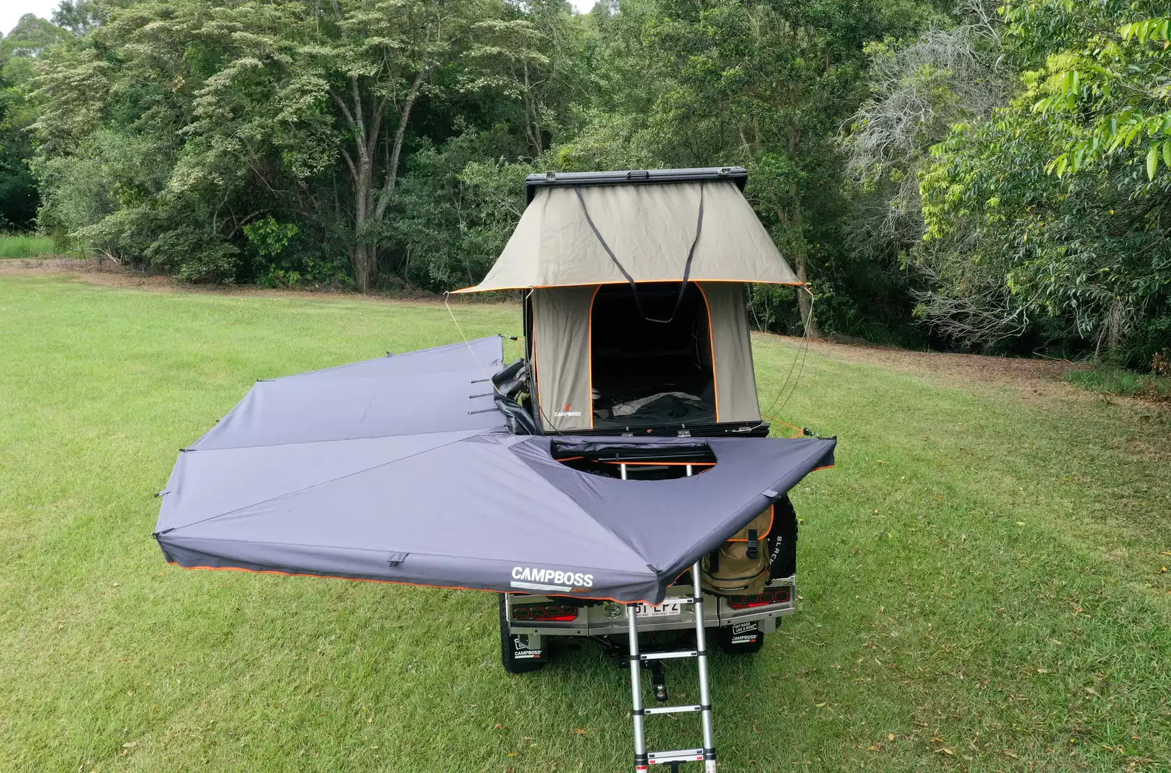 4x4 parked on the grass for a bivouac with a tent and a Awning