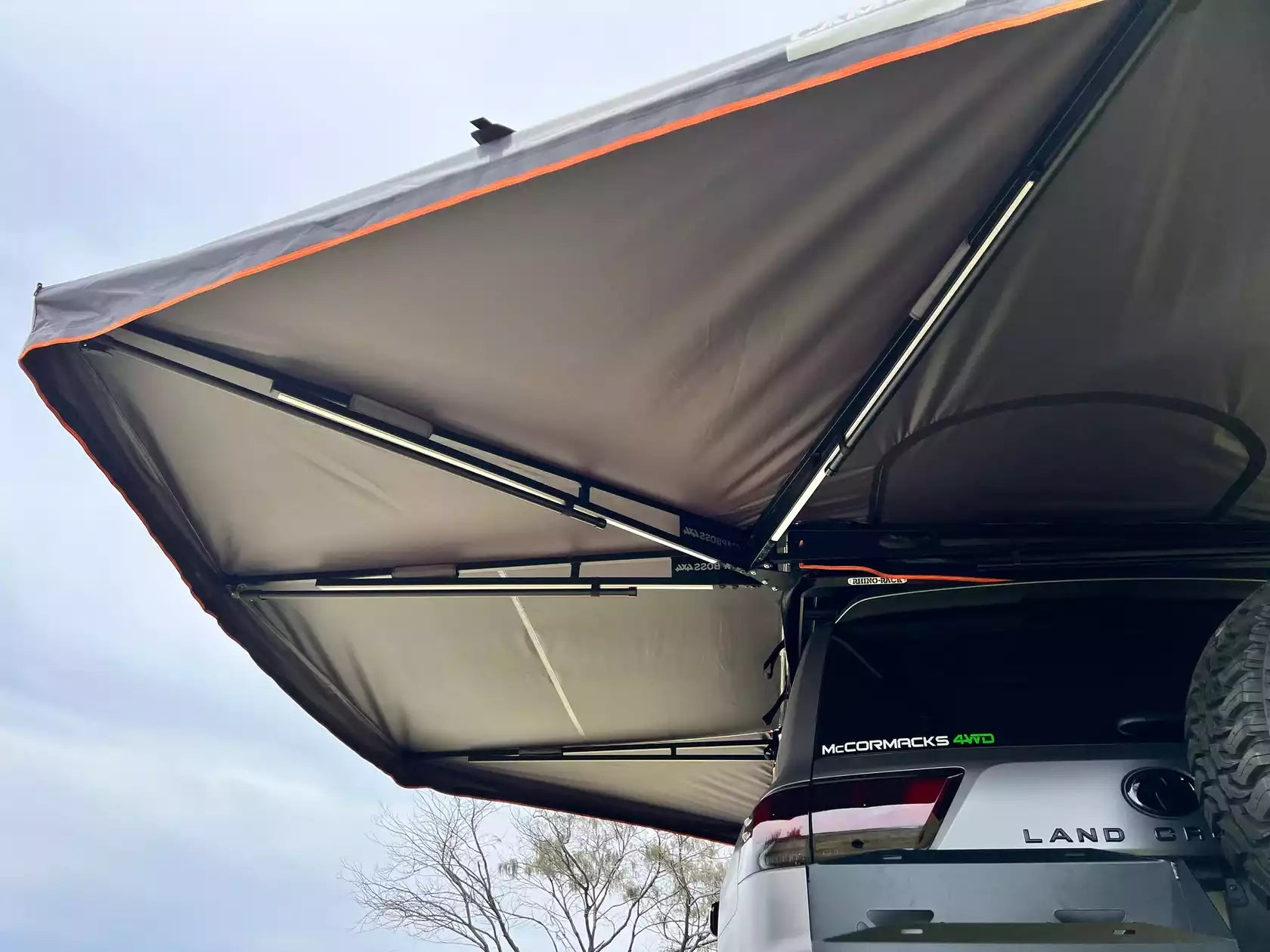 Underneath a black circular Awning opening along the entire length