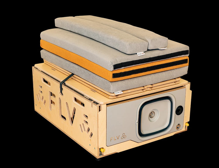 Folded wooden box with grey mattress on top