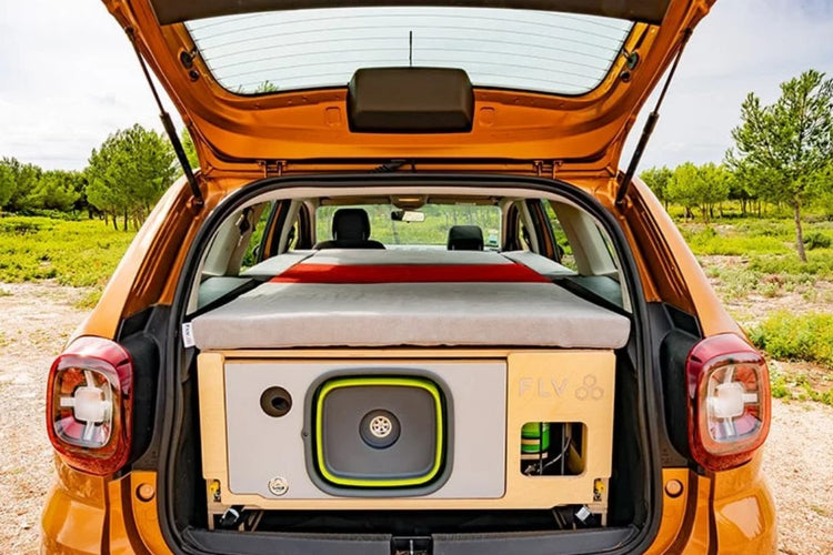 Dacia Duster orange open trunk with wood furnishings and mattress