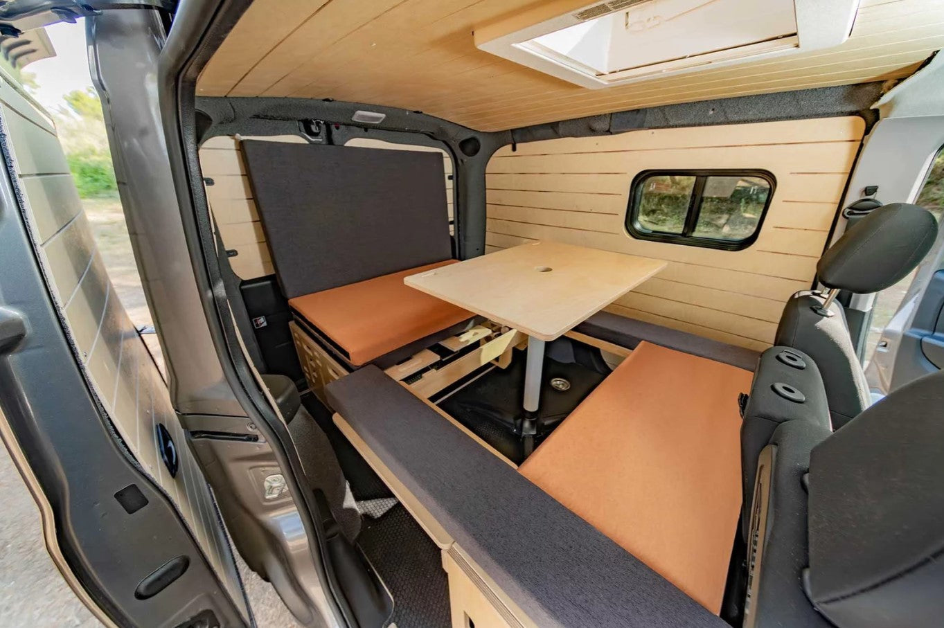 interior of a van with wooden bench and table
