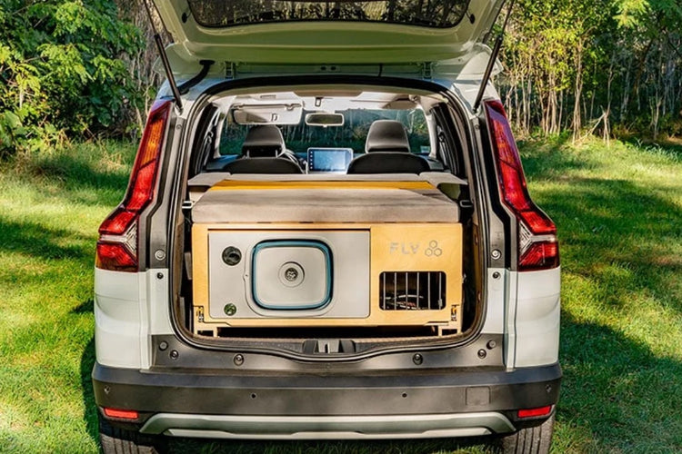 FLV box closed in a station wagon with a mattress unfolded on top