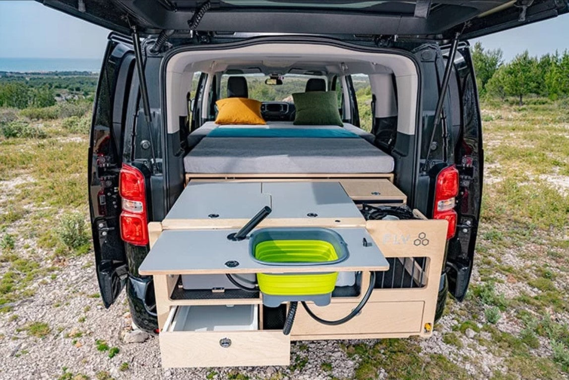 Unfolded interior with kitchen and mattress in a van