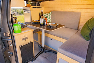 interior of a van with FLV bed and kitchen layout