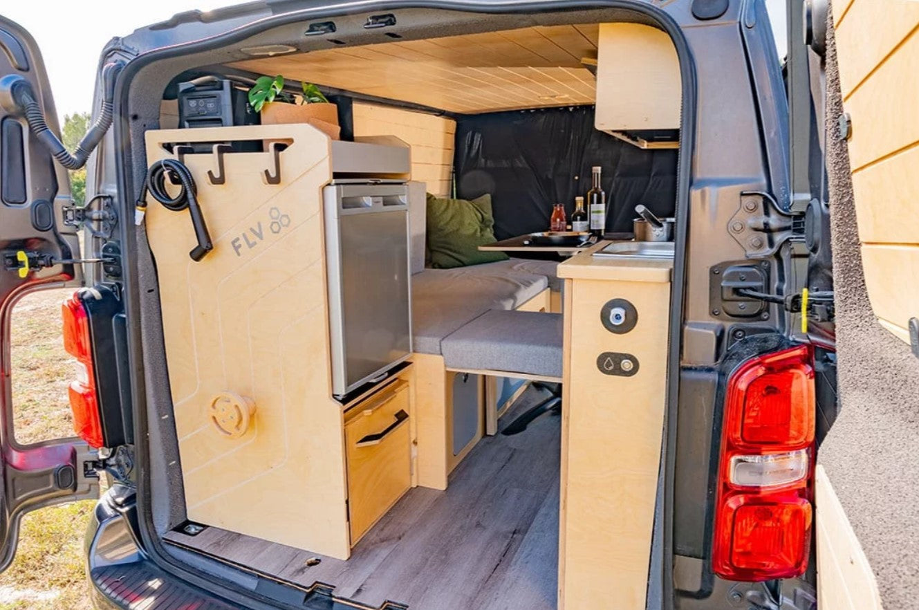 interior of a van with kitchen and bed area