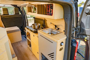 Kitchen area of a VAN fitted out with a sink near the rear door