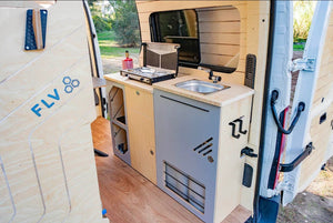 Rear view of a van with sink module and kitchen on edge