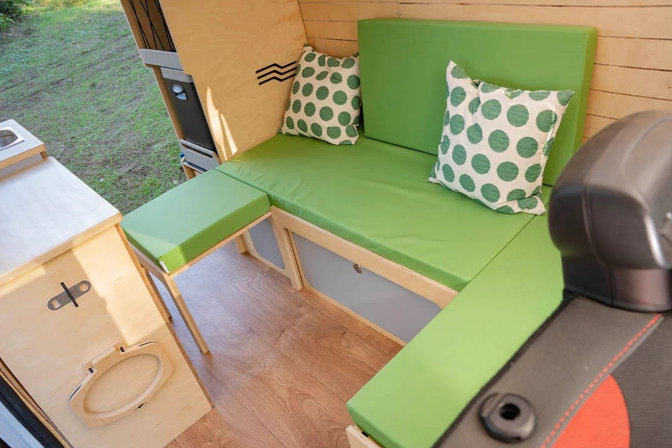 green U-shaped bench bed behind the seats