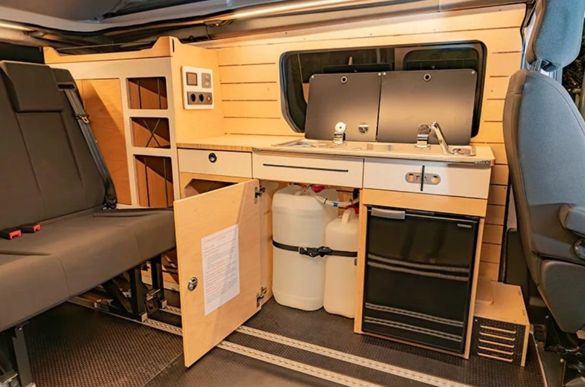 module of a van fitted with two water tanks under the kitchen area