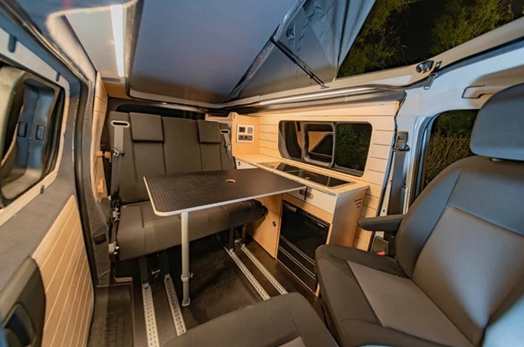 small van interior with swivel seats and wood fittings