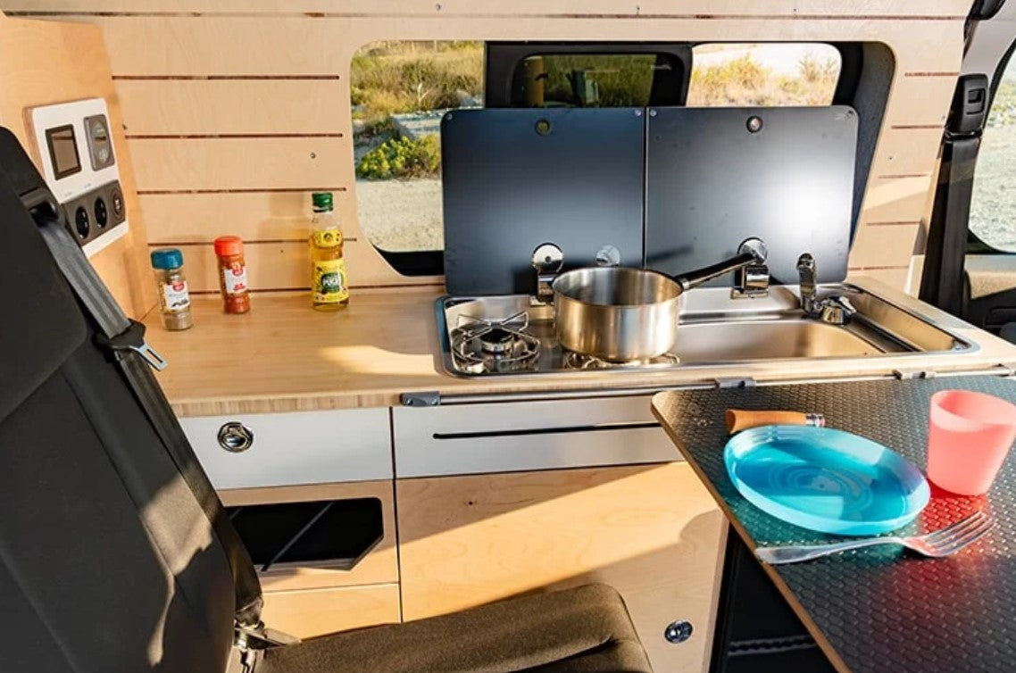 wood furnishings in a VAN with a saucepan on the stove