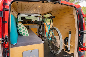 the back of a red van fitted out entirely in wood