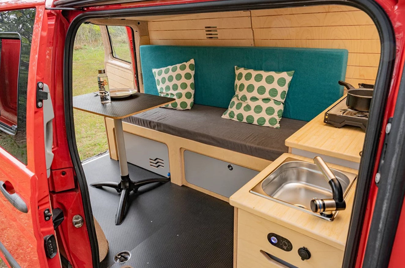 van with bed and table in a red van