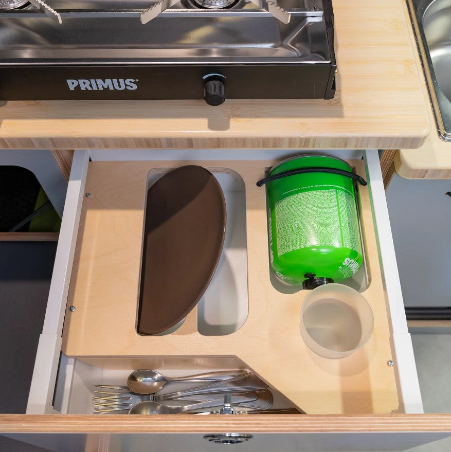 gas bottle and cutlery stored in a drawer under primus lights
