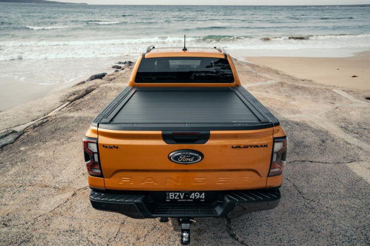 rear view of a ford ranger oranger in front of the sea