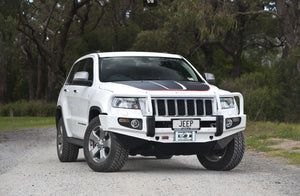 White and black Jeep grand Cherokee parked on a road with an ARB bumper