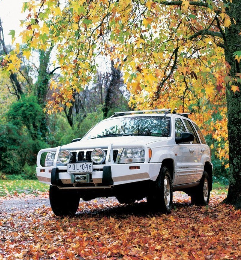 Jeep Grand Cherokee with white ARB bumper in leaves