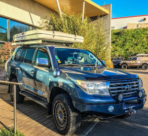 Toyota Land Cruiser 200 in front of a building with roof tent