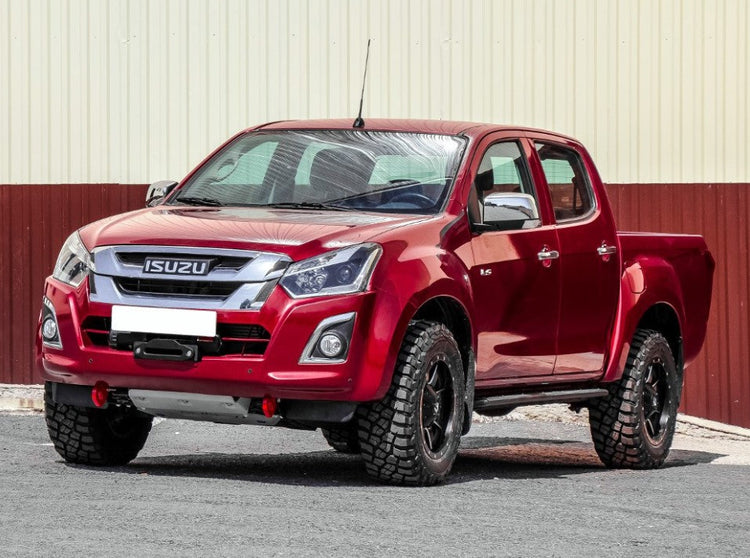 isuzu d-max red parked in front of a red and white building