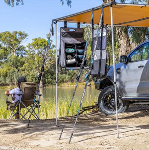 vehicle parked with a Awning in front of a lake