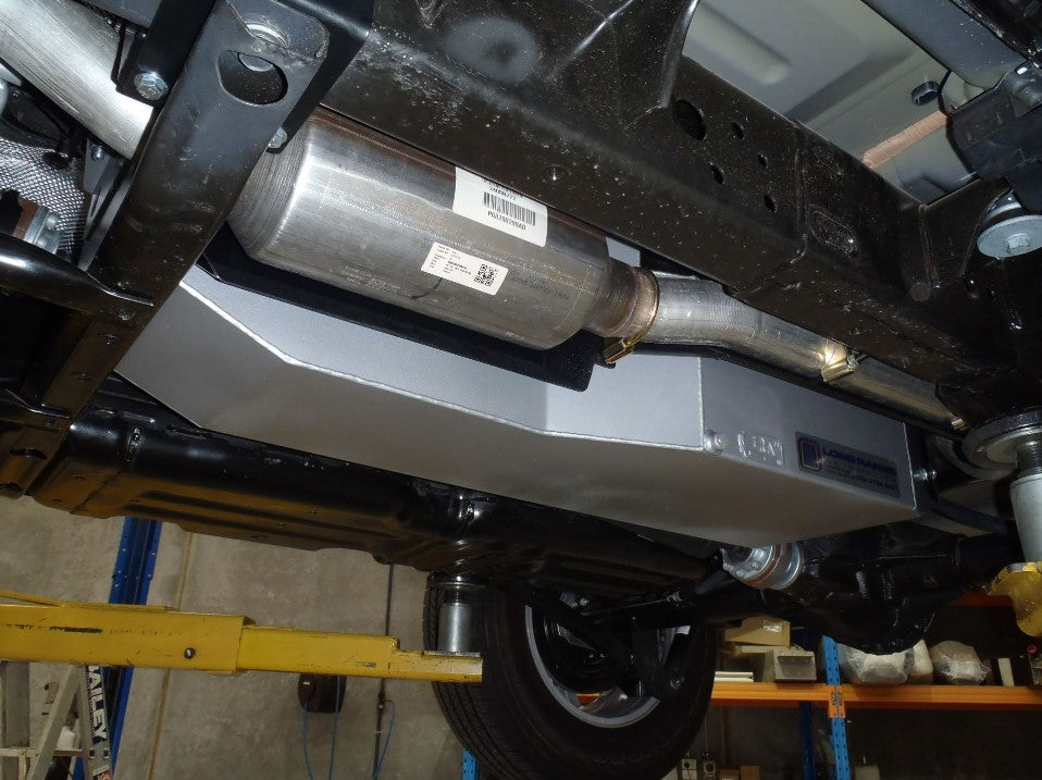 View of the underside of a vehicle with an exhaust system and an additional grey fuel tank.