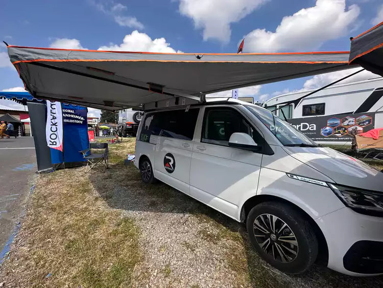 White van with an unfolded Awning self-supporting side panel