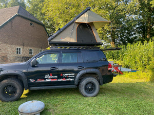 Roof tent with rigid aluminum shell on black 4X4