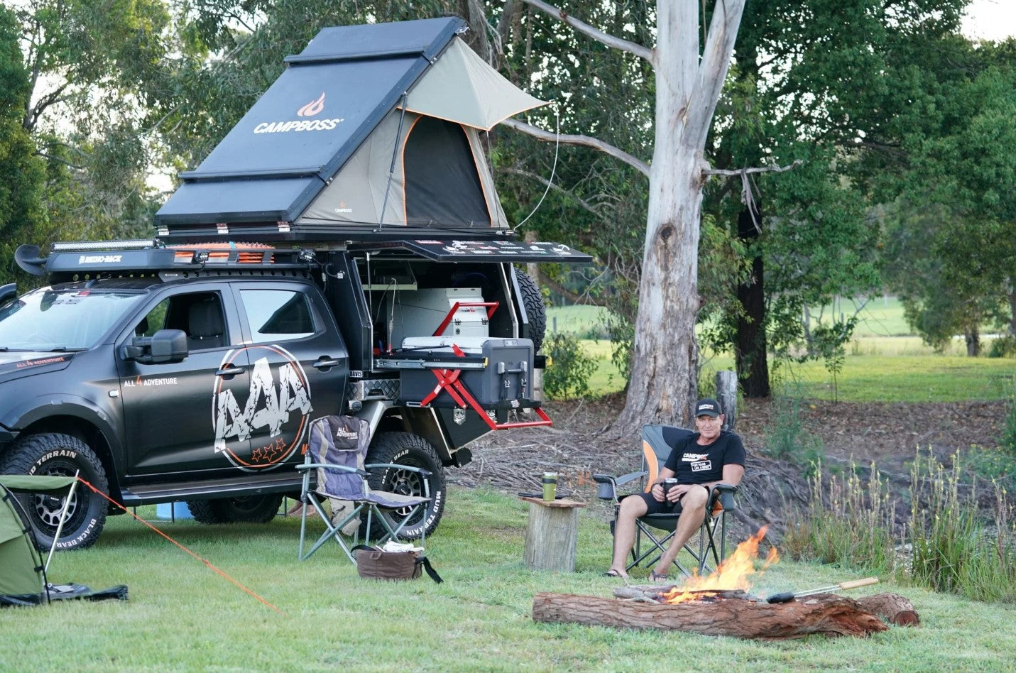 Man enjoying his camping space with his 4x4 and a Campboss rigid aluminium roof tent