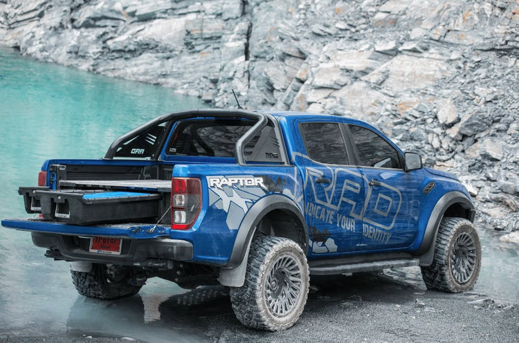 Blue Ford Ranger Raptor with open drawer in the Bed Truck on the water