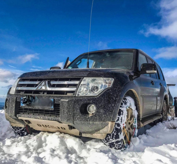 Black Mitsubishi Pajero in the snow with front armor