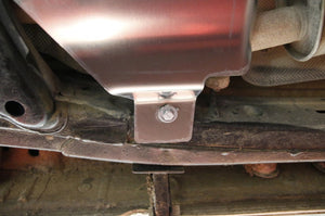 end of an aluminum guard bolted to the underside of the vehicle