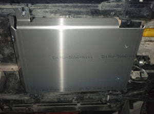 aluminium armour fixed under a vehicle with writing on it