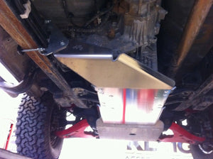 transfer case protected under a vehicle by an aluminium shield