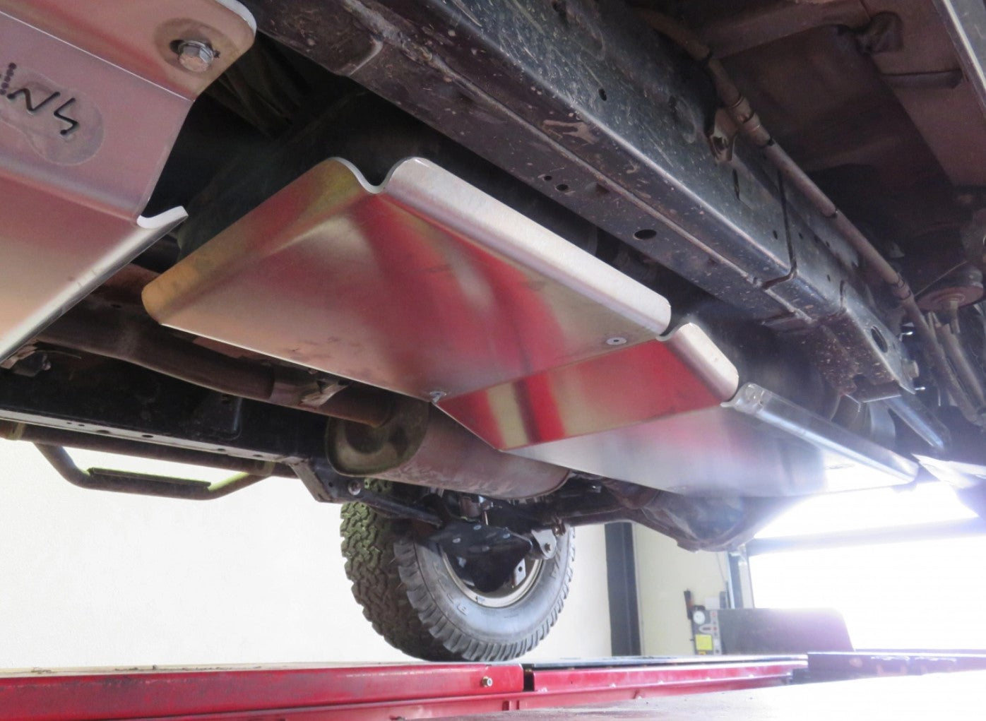 mounted view of an aluminum protective ski under a clean vehicle