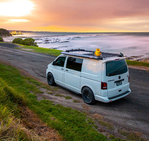 Volkswagen Transporter white in front of the sea