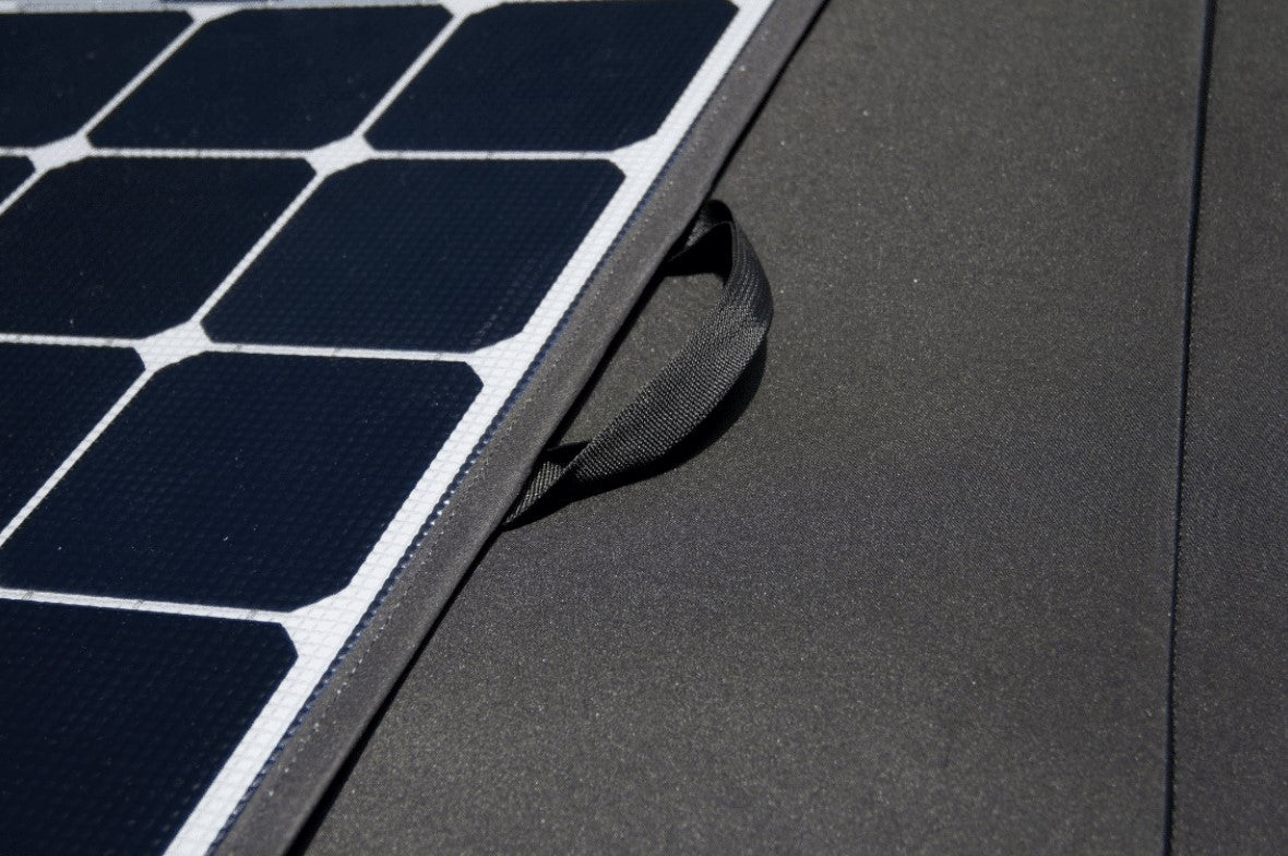 black handle next to square solar modules