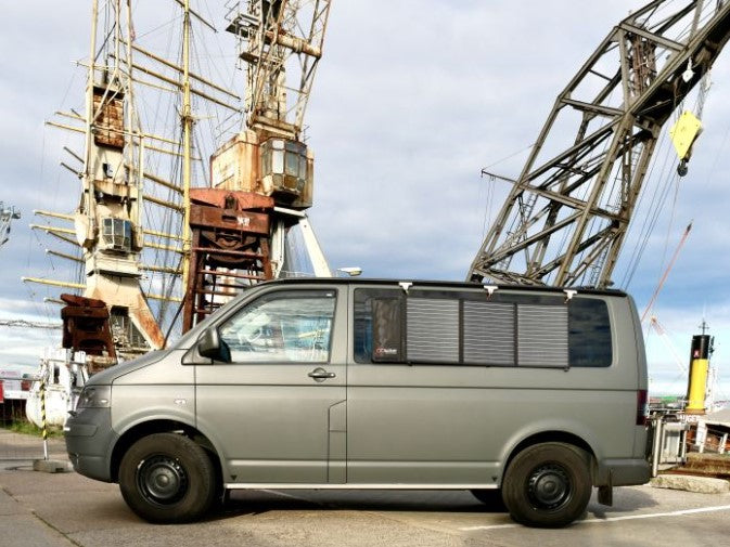 transport in front of large vehicles with a solar panel on the rear door