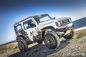 suzuki jimny white and black N4 offroad on a rocky landscape