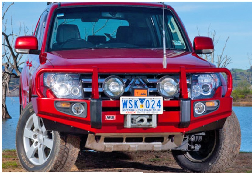 Red Mitsubishi Pajero with matching bumper color