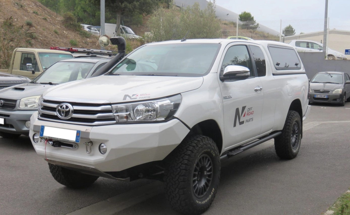 White Toyota Hilux parked with snorkel and steel pc