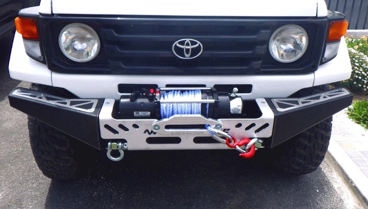 white land cruiser with black and grey steel bumper and winch