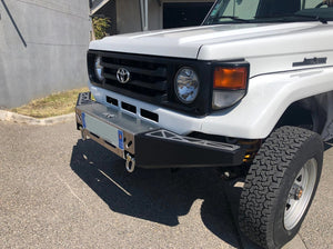 front left view of a vehicle equipped with a black and grey bumper