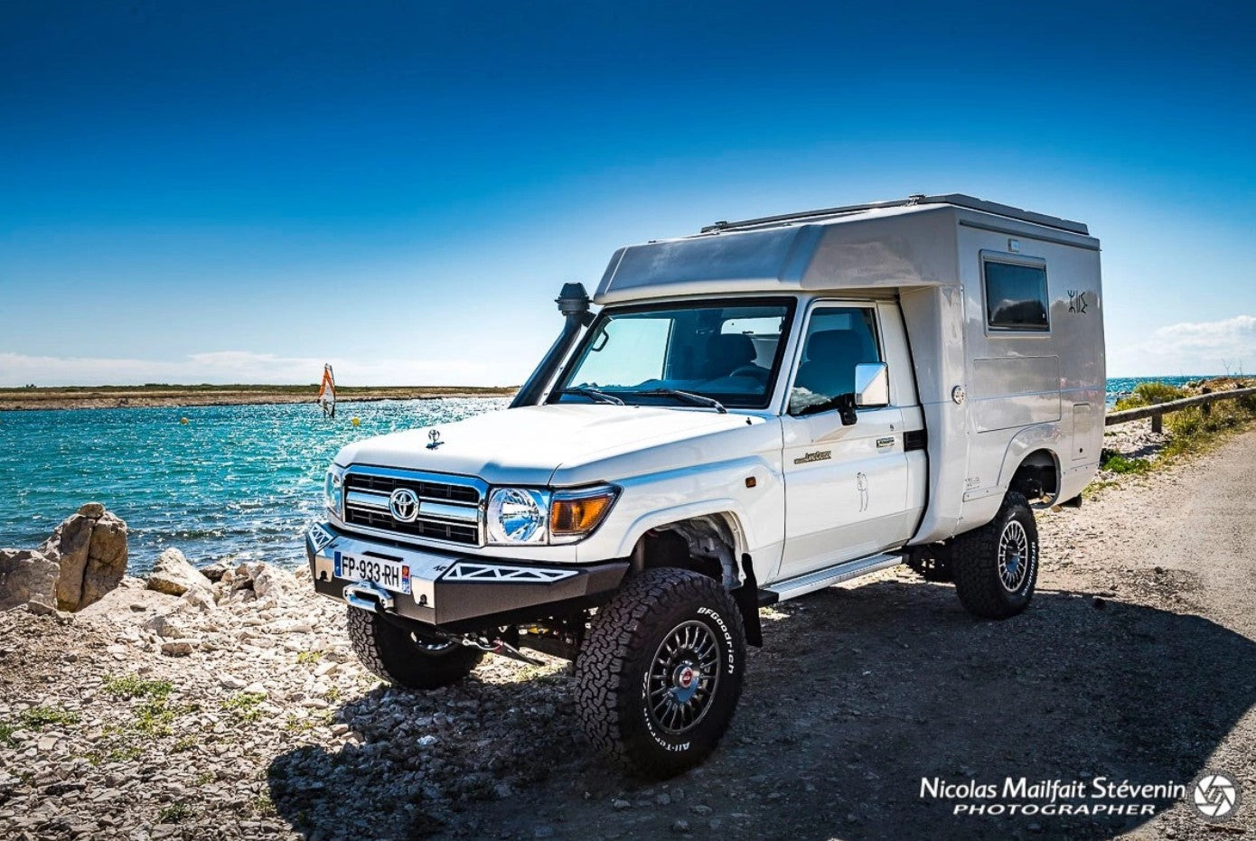 Land Cruiser in front of the sea with airframe