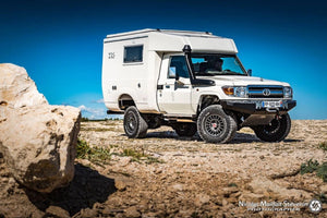 Land Cruiser in front of the sea with white cell